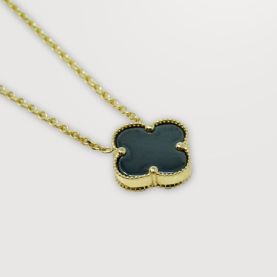 Close up of single onyx four leaf clover necklace in 14k yellow gold | GOLDZENN