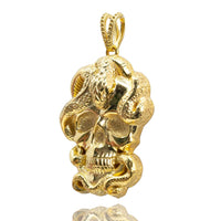 The Snake Skull Pendant – 14K Gold Men Pendant features a detailed skull entwined with a textured snake, hanging from a decorative bail with a shiny, reflective 14K gold finish.