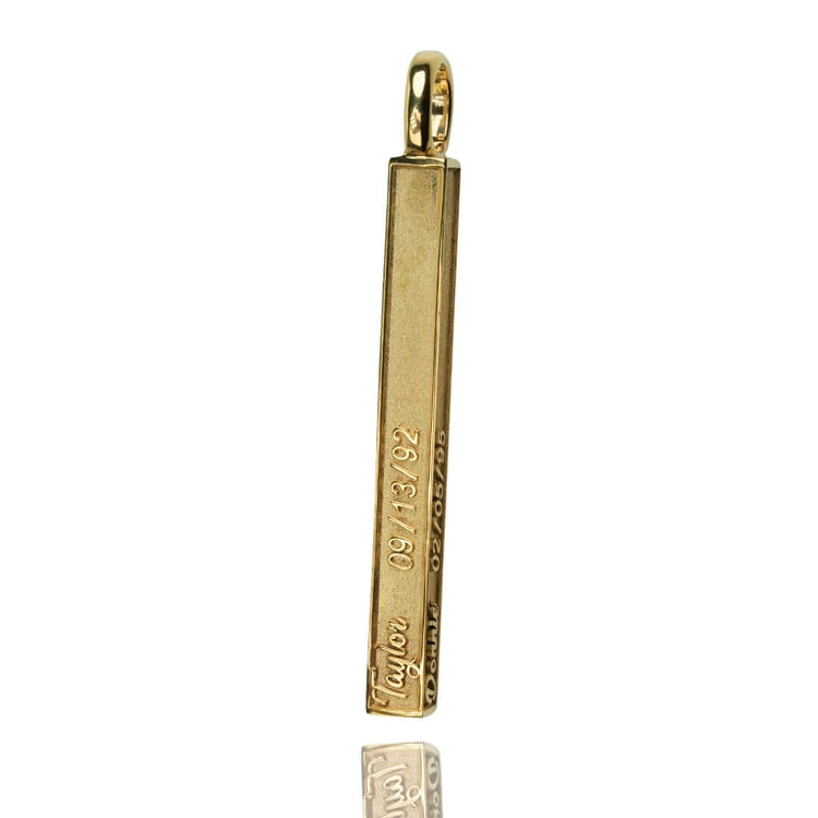 The Solid Name Bar Pendant is a polished gold bar with engraved numbers and text on its sides, plus a top loop for easy chain attachment—ideal for anyone who loves personalized jewelry.