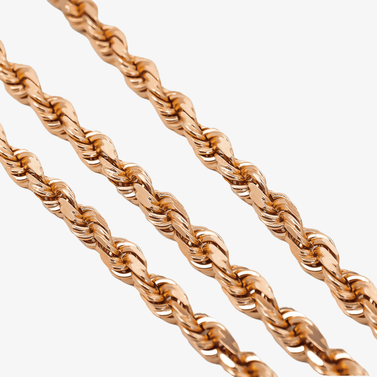 Close-up of three Rope Chain - 6mm-12mm Solid Rose Gold chains aligned diagonally on a white background. Their twisted, interwoven design shines with a polished finish—ideal for creating a standout statement necklace.