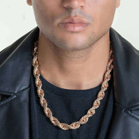 A person wearing the 6mm-12mm Solid Rose Gold Rope Chain, a black mesh shirt, and a black leather jacket, shown from the shoulders up with a neutral expression.