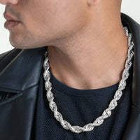 A man wears the Rope Chain - 6mm-12mm Solid White Gold, paired with a black mesh shirt and black leather jacket. Only the lower half of his face and neck are visible.