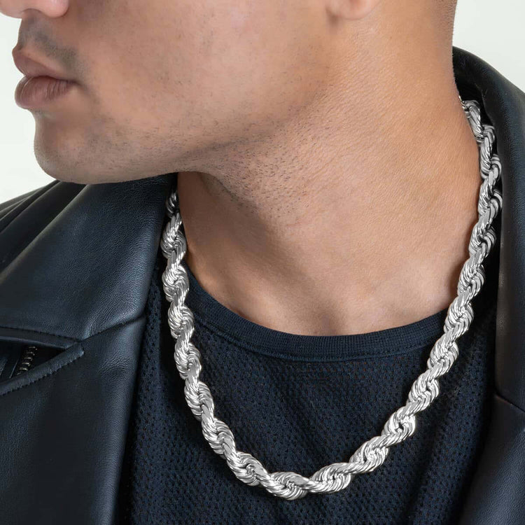 A man wears the Rope Chain - 6mm-12mm Solid White Gold, paired with a black mesh shirt and black leather jacket. Only the lower half of his face and neck are visible.