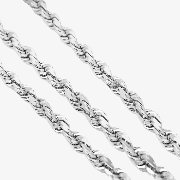 Close-up of three Rope Chain - 6mm-12mm Solid White Gold pieces displayed diagonally on a plain white background, showcasing their twisted, textured design.