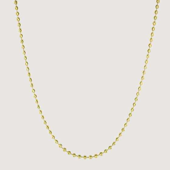 Alt="gold chain featuring moon cut bead design for a textured look."