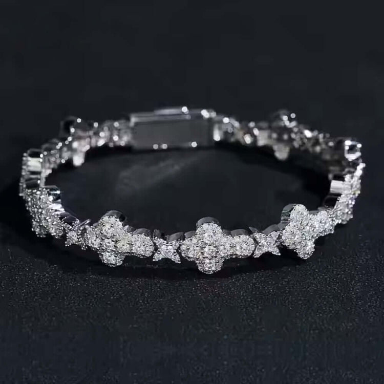The Moissanite Cross Fancy Bracelet is crafted from 925 sterling silver, featuring cross-shaped links adorned with sparkling moissanite stones, shown on a dark, textured surface.