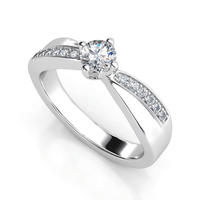 The Split-Band Lab Diamond Ring with Pavé Detailing features a round lab-grown diamond in a four-prong setting, with accent stones on the split shank—an elegant choice for women's engagement.