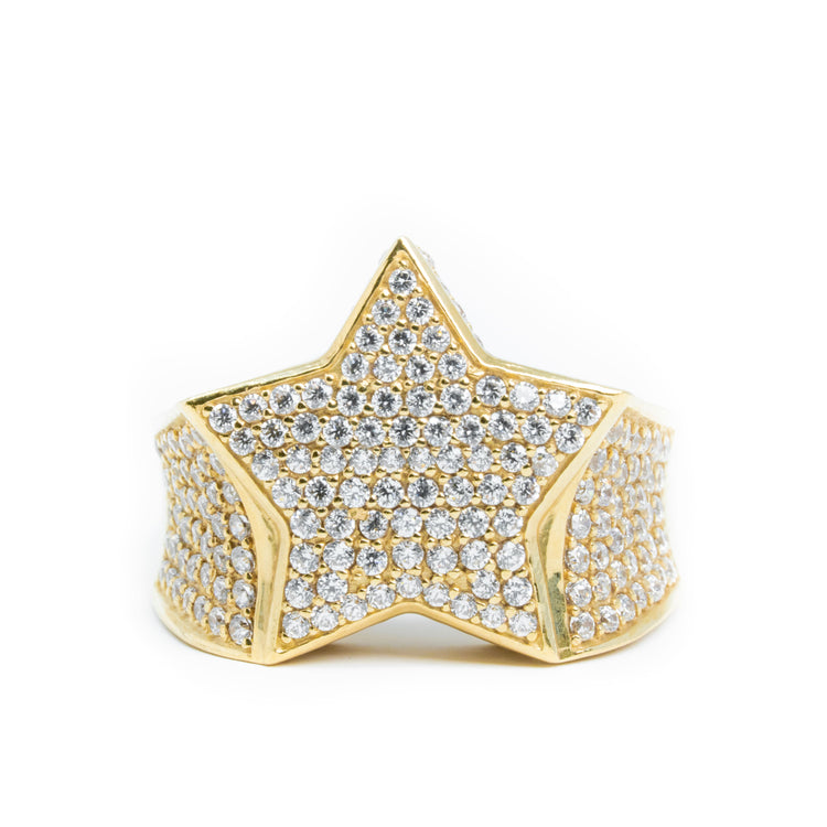 The Star Men's Ring - 14k Gold features a bold star-shaped front encrusted with sparkling stones, while the band is also set with matching gems. This solid gold men's ring stands out as a striking and luxurious accessory.