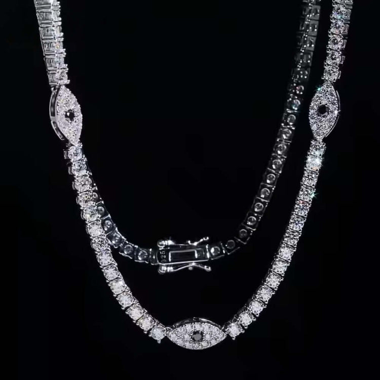 The Evil Eye Tennis Chain - 3mm is a stunning silver necklace adorned with sparkling diamonds, featuring the signature Evil Eye design for unique protection and elegance.