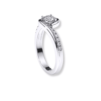 The Swirl Pavé Round-Cut Lab Diamond Engagement Ring features a round center lab diamond and a row of pavé diamonds along one side of its white gold band, displayed on a white background.