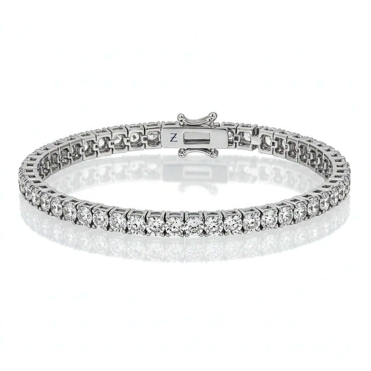 The Tennis Bracelet - 925 Silver Moissanite features a continuous row of sparkling moissanite stones in classic prong settings, elegantly showcased on a white background.