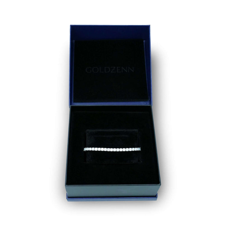The Tennis Bracelet - 925 Silver Moissanite is displayed in a black velvet jewelry box with a dark blue exterior and the GOLDZENN logo on the inside lid, emphasizing the bracelet’s elegance.