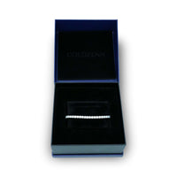 The Tennis Bracelet - 925 Silver Moissanite is displayed in a black velvet jewelry box with a dark blue exterior and the GOLDZENN logo on the inside lid, emphasizing the bracelet’s elegance.