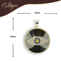 The Eye Pendant – 10k features a gold and black circular design, 29mm wide, with blue and clear gemstones at its center. Displayed on a white background with size details, it's a bold statement piece for men's jewelry collections.