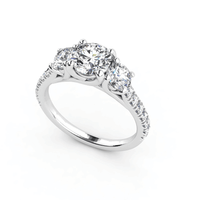 The Elegant Trio in White Gold is a three-stone lab diamond engagement ring, featuring a large center stone with two side diamonds and accents along the band—an exquisite women's engagement ring on a white background.
