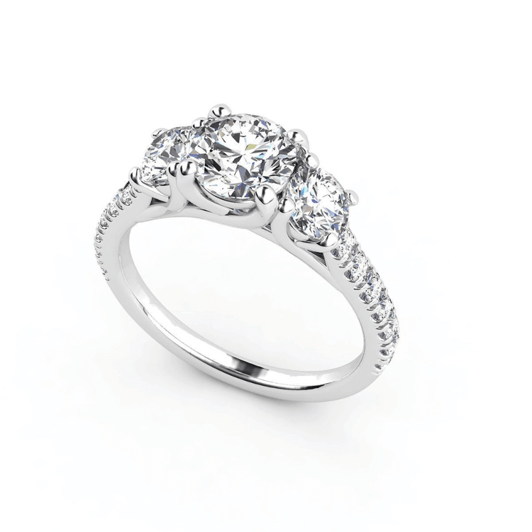 The Elegant Trio in White Gold is a three-stone lab diamond engagement ring, featuring a large center stone with two side diamonds and accents along the band—an exquisite women's engagement ring on a white background.