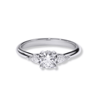 The Three-Stone Round Lab Diamond Ring with Pear-Cut Side Stones features a large round center lab diamond and two smaller pear-cut diamonds on a polished silver band, shown on a white background—ideal for modern women's engagement rings.