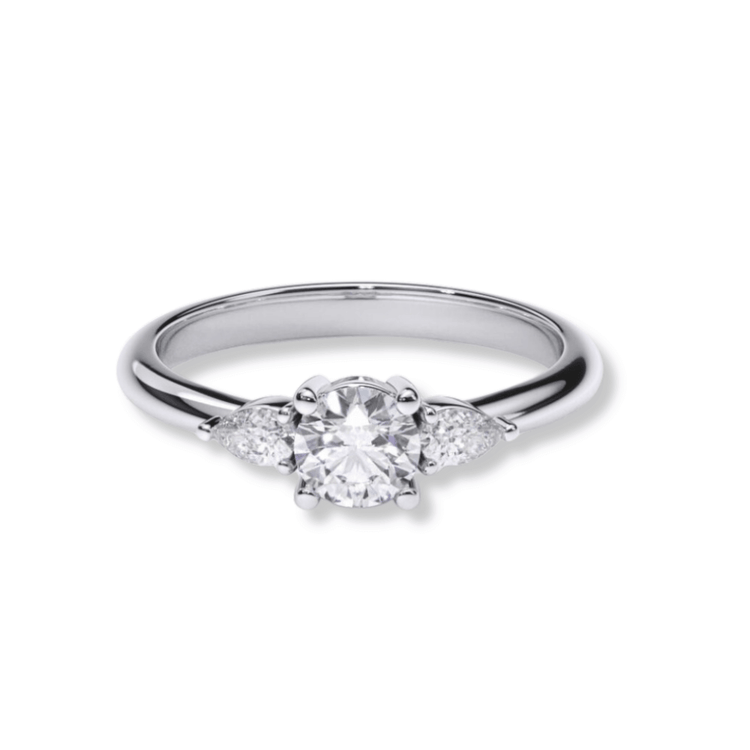 The Three-Stone Round Lab Diamond Ring with Pear-Cut Side Stones features a large round center lab diamond and two smaller pear-cut diamonds on a polished silver band, shown on a white background—ideal for modern women's engagement rings.