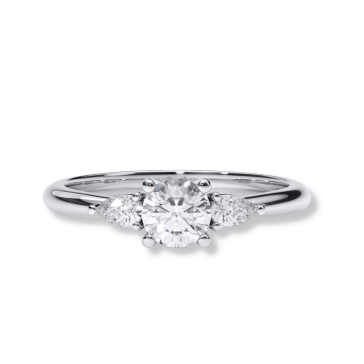 The Three-Stone Round Lab Diamond Ring with Pear-Cut Side Stones features a round center stone and two pear-shaped diamonds on a slender white gold or platinum band—an elegant women's engagement ring choice.