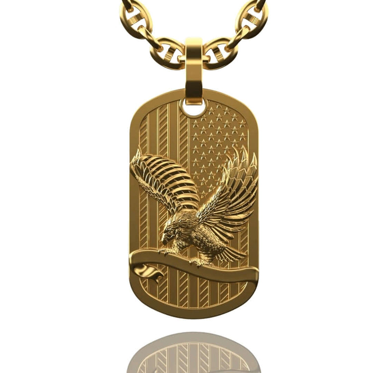 Show your patriotism with the US Flag & Eagle Tag Pendant – a 14K gold men's pendant featuring an engraved US flag and a detailed eagle with outstretched wings perched on a branch above a reflective surface.
