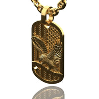 The US Flag & Eagle Tag Pendant – 14K Gold Men Pendant features a raised eagle with outstretched wings, set against a textured striped background. This rectangular, polished pendant is ideal for those who appreciate patriotic jewelry.
