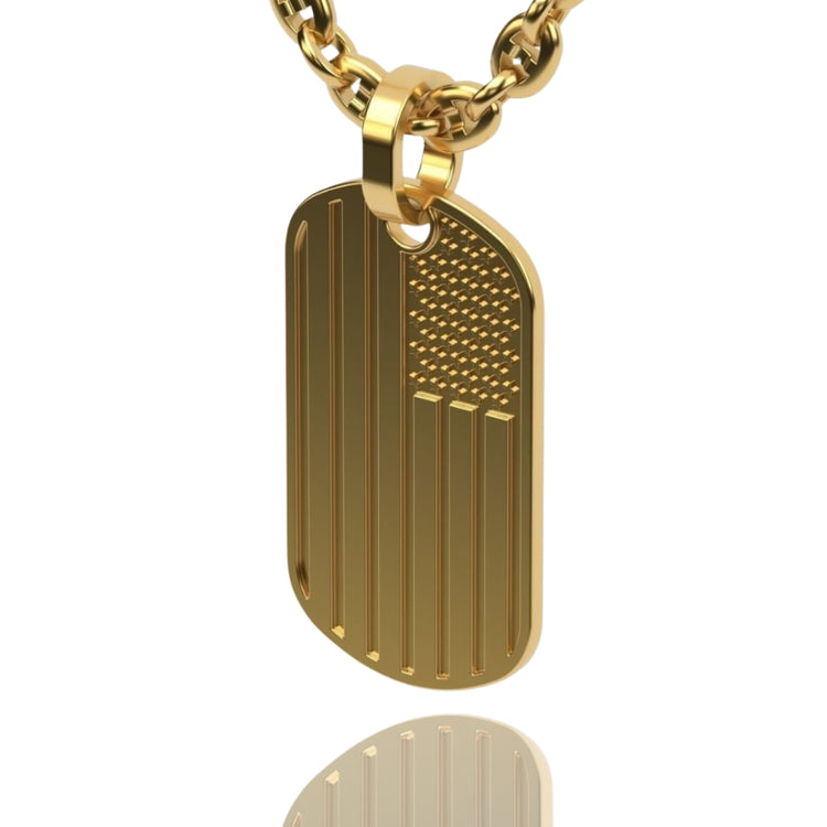 The USA Flag Tag Pendant is a gold patriotic necklace featuring a polished dog tag design engraved with raised stripes and dots for the flag’s stars. Its reflective finish adds a striking touch, making it a standout accessory.