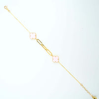 The 3 Leaf Clover Bracelet - 14k Yellow Gold features two pink clover-leaf charms and a gold rectangular link, shown against a white background.