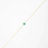 The one lucky eye bracelet - 14k features a delicate gold chain with a small, colorful evil eye charm at the center for spiritual protection, displayed on a plain white background.