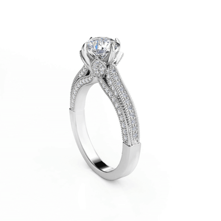 A Vintage Milgrain Solitaire Lab Engagement Ring with Pavé Diamond Band in white gold, featuring a round brilliant-cut solitaire and intricate pavé accents, photographed on a plain white background.