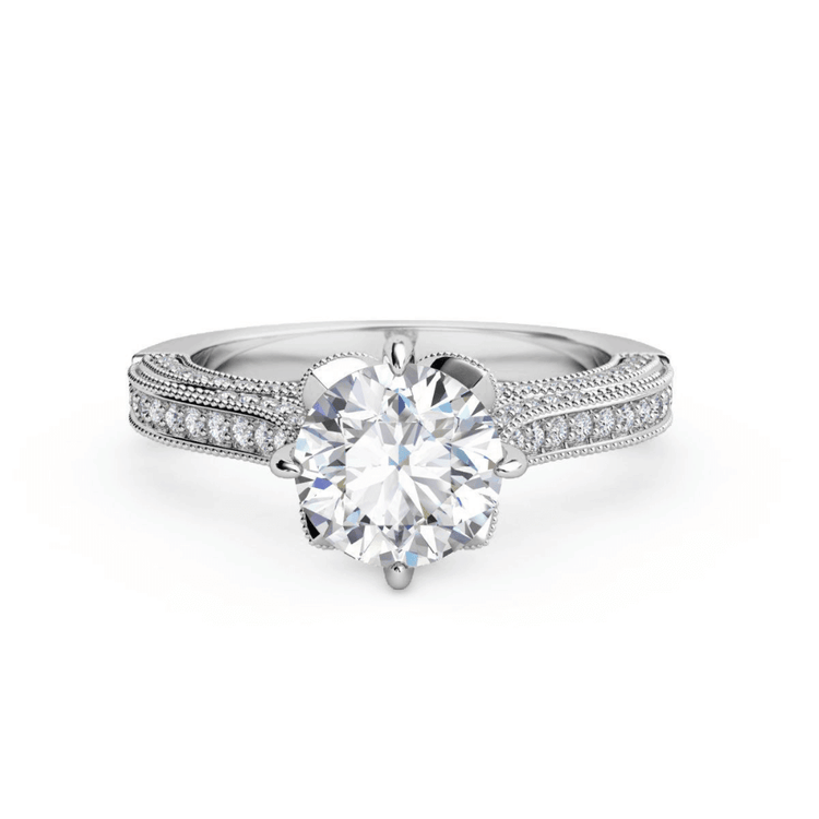 The Vintage Milgrain Solitaire Lab Engagement Ring features a large round lab diamond center, pavé diamond band, and vintage milgrain detailing in white gold or platinum.