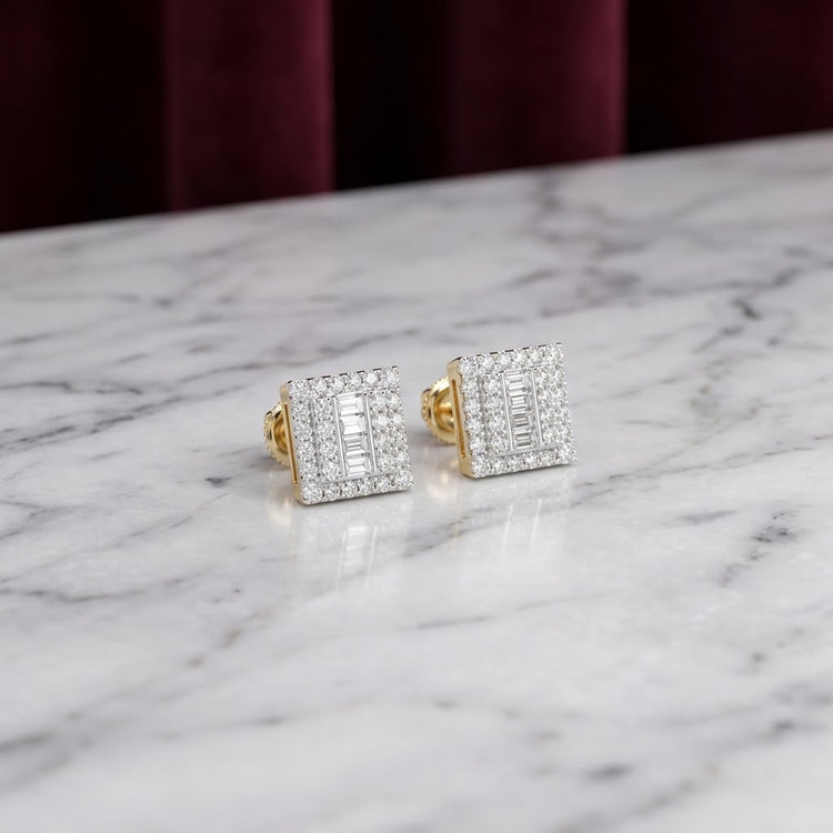 10K Gold Diamond Square Earrings 1/2 CTTW rest on a white marble surface, with a blurred dark red curtain in the background—showcasing their timeless elegance in yellow gold.