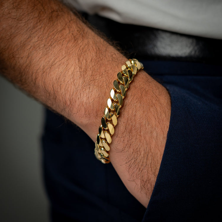 Man wearing the GOLDZENN 11mm solid yellow gold handmade Miami Cuban link bracelet on the wrist.