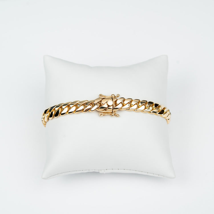 GOLDZENN 8mm handmade Miami Cuban link bracelet in solid yellow gold, showing the hand-made box lock with dual figure-8 safety latches.