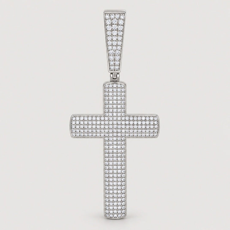 A striking Moissanite Cross Religious Charm Pendant by GOLDZENN, adorned with small sparkling moissanite stones and set in sterling silver, features a diamond-studded bail at the top. This elegant jewelry piece is beautifully showcased against a plain light background.