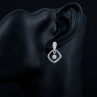 1/10CT Natural Diamond Earrings in Sterling Silver displayed on ear - GOLDZENN