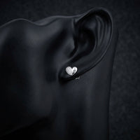 1/10CT Diamond Heart Earrings – Sterling Silver displayed on ear - GOLDZENN