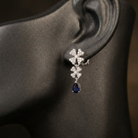 3/8CTW Diamond Flower Earrings 14k White Gold displayed on ear - GOLDZENN