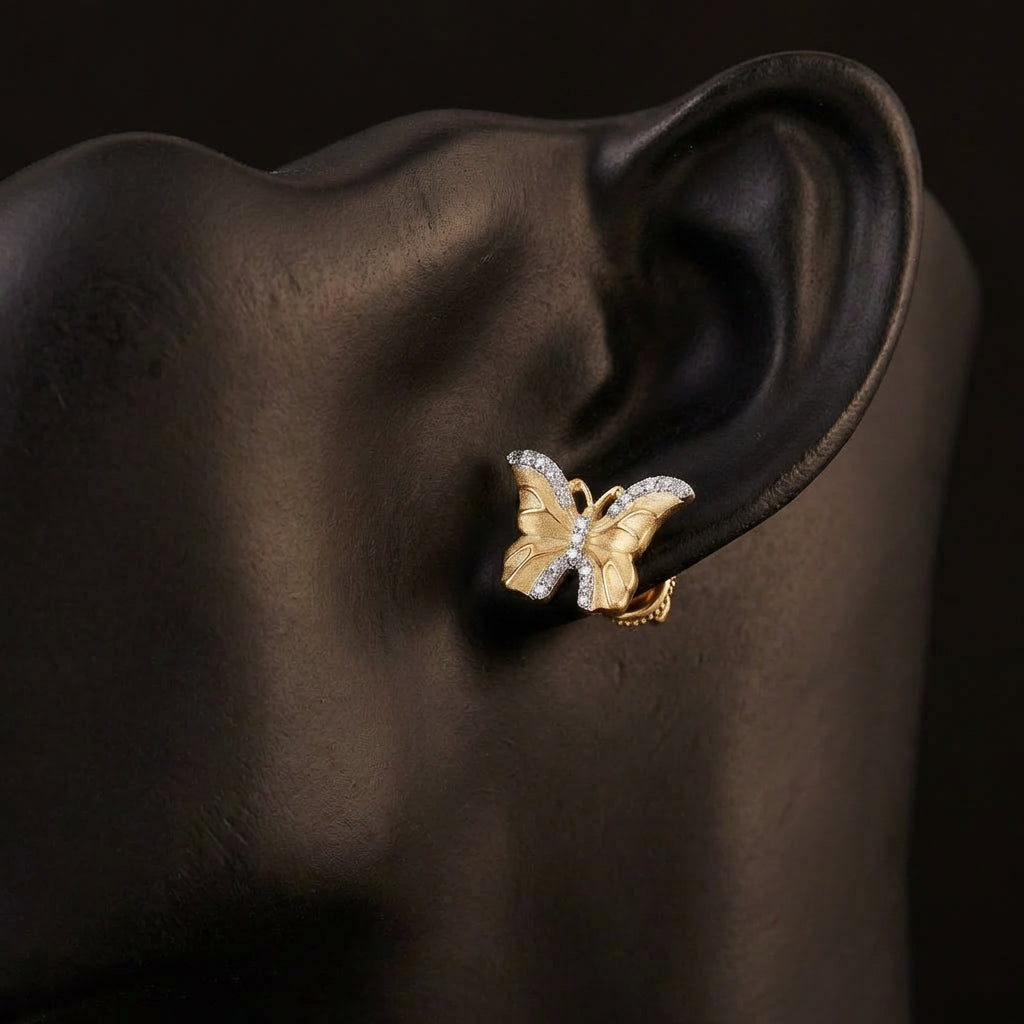 1/6 CTW Diamond Butterfly Earrings in 10k Yellow Gold displayed on ear - GOLDZENN
