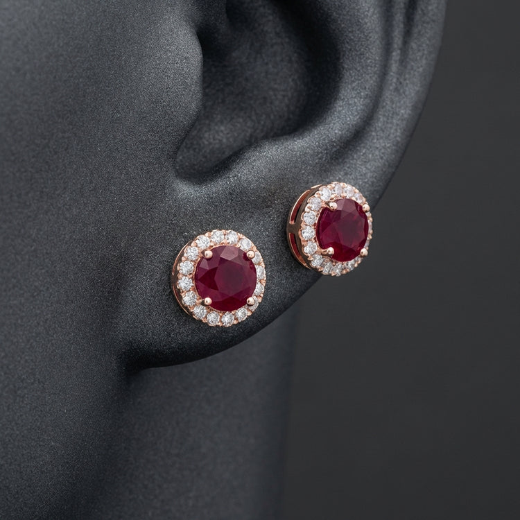 1-1/5CTW Round Ruby Halo and Diamond Solitaire Stud Earrings - 14K Rose Gold displayed on ear - GOLDZENN
