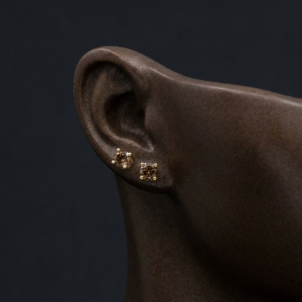 1/4CTW Round Brown Diamond Solitaire Stud Earrings - 10K Yellow Gold displayed on ear - GOLDZENN
