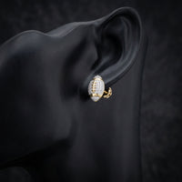 10k Gold Diamond Football Earrings 1/3 Cttw displayed on ear - GOLDZENN