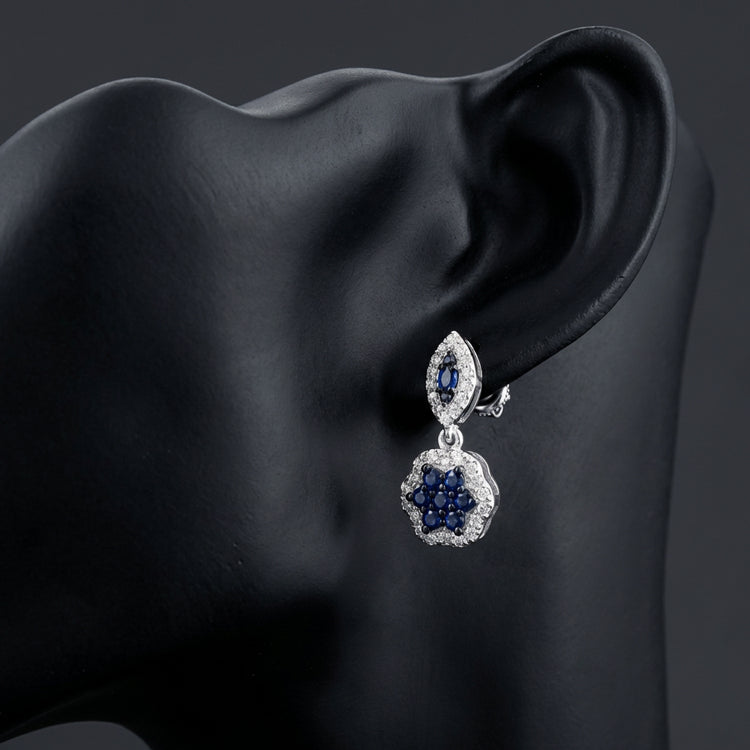 1/3CTW Diamond Flower Dangling Earrings 10k White Gold displayed on ear - GOLDZENN