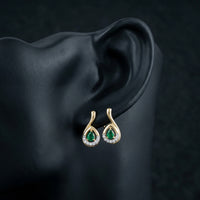1/20CTW Natural Diamond Earrings in 14k Yellow Gold displayed on ear - GOLDZENN