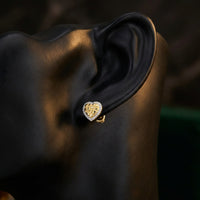 10k Yellow Gold Diamond Heart Earrings 1/10 Cttw displayed on ear - GOLDZENN