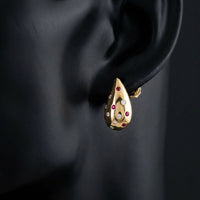 14k Gold Diamond & Ruby Teardrop Earrings 1/3CTW displayed on ear - GOLDZENN