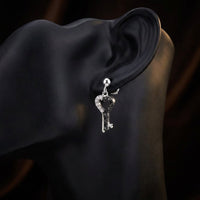 10k White Gold Black Diamond Key Heart Earrings displayed on ear - GOLDZENN
