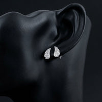 1/20CTW Round Diamond Angel Wing Stud Earrings - 14K White Gold displayed on ear - GOLDZENN