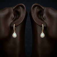 10k Yellow Gold Pear Opal Diamond Dangling Earrings displayed on ear - GOLDZENN