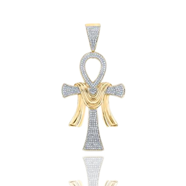 The 10k Gold Diamond Ankh Cross Pendant 3/4 CTTW features a gold and silver design with small diamonds, a textured gold ribbon accent, and is presented against a white background.