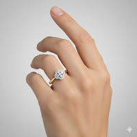 A hand with manicured nails wears the 10k White & Rose Gold Diamond Clover Ring 1/4 Cttw, featuring a clover design with sparkling diamonds, set against a plain light gray background.